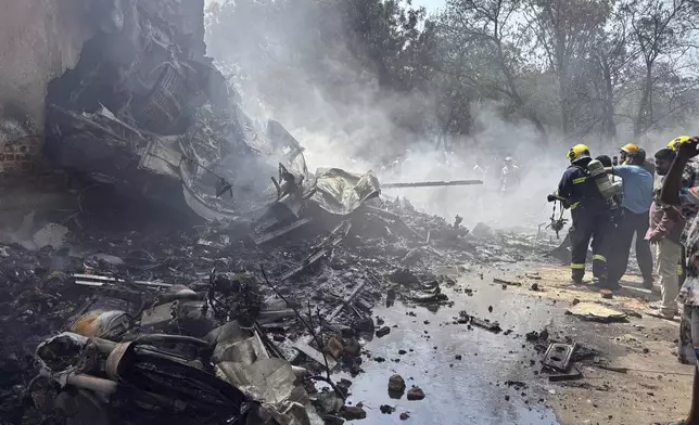 Firefighters work at the site of an airplane that crashed in India's northwestern city of Ahmedabad in Gujarat state, Thursday, June12, 2025. (AP Photo/Ajit Solanki)
