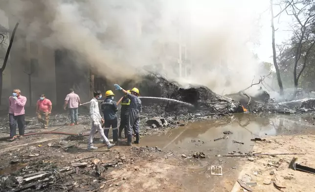 Firefighters work at the site of an airplane that crashed in India's northwestern city of Ahmedabad in Gujarat state, Thursday, June 12, 2025. (AP Photo/Ajit Solanki)