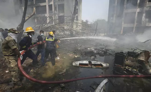 Firefighters work at the site of an airplane that crashed in India's northwestern city of Ahmedabad in Gujarat state, India, Thursday, June 12, 2025. (AP Photo/Ajit Solanki)