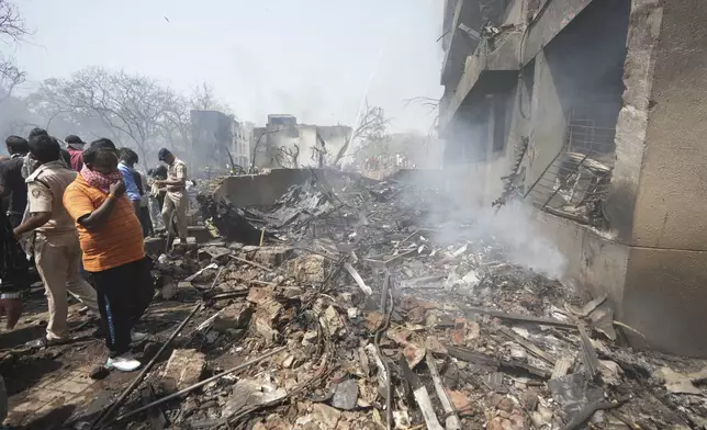 Members of the security forces work at the site of an airplane that crashed in India's northwestern city of Ahmedabad in Gujarat state, Thursday, June 12, 2025. (AP Photo/Ajit Solanki)