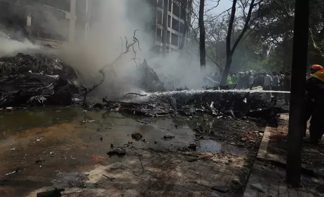 Firefighters work at the site of an airplane that crashed in India's northwestern city of Ahmedabad in Gujarat state, Thursday, June 12, 2025. (AP Photo/Ajit Solanki)