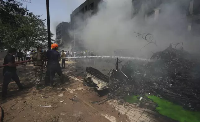 Firefighters work at the site of an airplane that crashed in India's northwestern city of Ahmedabad in Gujarat state, Thursday, June 12, 2025. (AP Photo/Ajit Solanki)