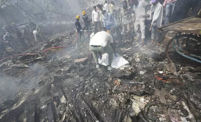 Rescuers work at the site of an airplane that crashed in India's northwestern city of Ahmedabad in Gujarat state, Thursday, June 12, 2025. (AP Photo/Ajit Solanki)