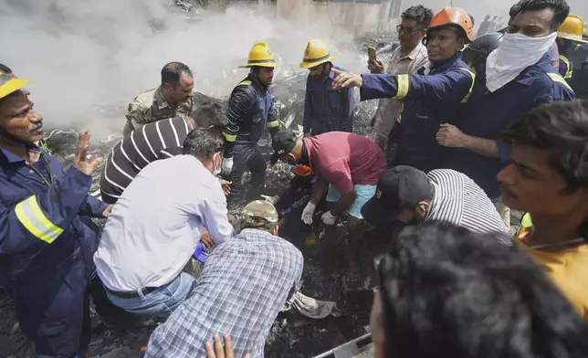 Rescuers work at the site of an airplane that crashed in India's northwestern city of Ahmedabad in Gujarat state, Thursday, June12, 2025. (AP Photo/Ajit Solanki)