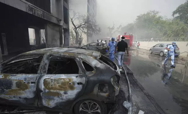Firefighters work at the site of an airplane that crashed in India's northwestern city of Ahmedabad in Gujarat state, India, Thursday, June 12, 2025. (AP Photo/Ajit Solanki)
