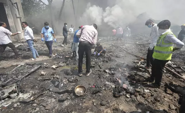 Rescuers at the site of a plane crash in Ahmedabad, India, Thursday, June 12, 2025. (AP Photo/Ajit Solanki)