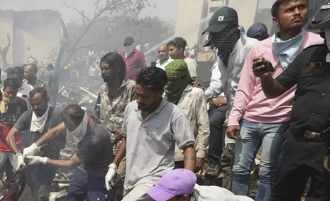 EDS NOTE GRAPHIC CONTENT- Rescuers work at the site of an airplane that crashed in India's northwestern city of Ahmedabad in Gujarat state, Thursday, June 12, 2025. (AP Photo/Ajit Solanki)