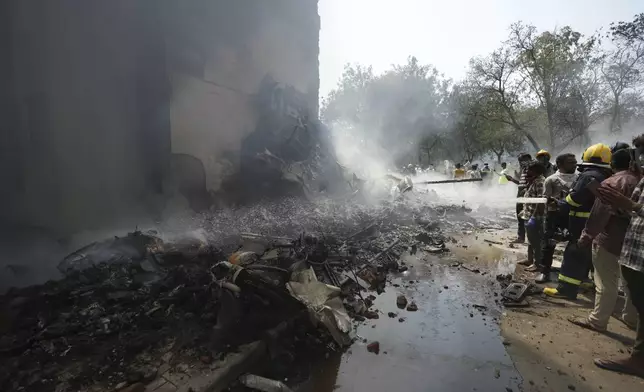 Firefighters work at the site of an airplane that crashed in India's northwestern city of Ahmedabad in Gujarat state, Thursday, June 12, 2025. (AP Photo/Ajit Solanki)