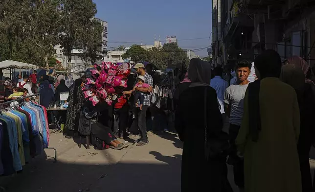 Palestinians walk trough a market ahead of the Muslim holiday of Eid al-Adha, in Gaza City on Thursday, June 5, 2025. (AP Photo/Jehad Alshrafi)