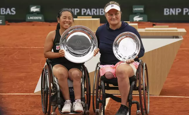 Winner Japan's Yui Kamiji, left, and Second placed Netherlands' Aniek Van Koot pose with trophies after their women's wheelchair singles final match of the French Tennis Open at the Roland-Garros stadium in Paris, Saturday, June 7, 2025. (AP Photo/Christophe Ena)