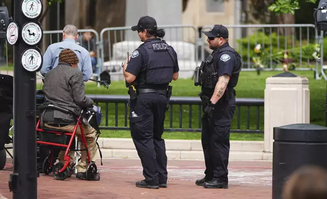 Police officers check on a person in front of the Boulder County, Colo., courthouse after an attack on the Pearl Street Mall Monday, June 2, 2025, in Boulder, Colo. (AP Photo/David Zalubowski)