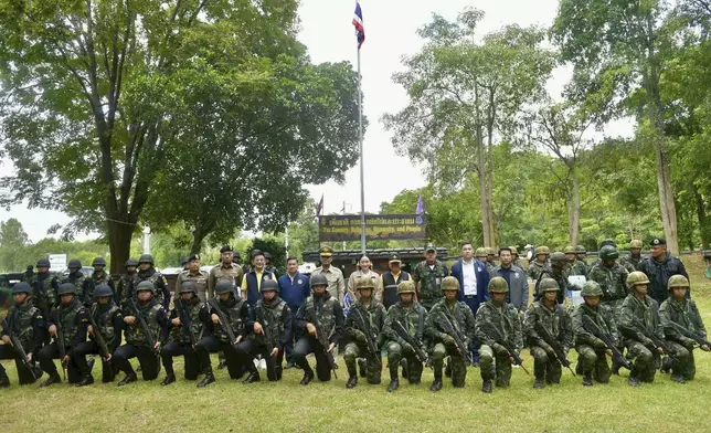 In this photo released by Thailand's Government Spokesman Office, Thailand's Prime Minister Paetongtarn Shinawatra, rear center, poses for media with Thai soldiers in Sa Kaeo Province Thailand, Thursday, June 26, 2025. (Thailand's Government Spokesman Office via AP)
