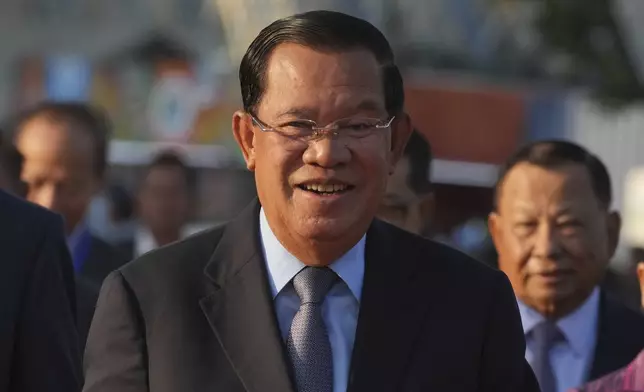 FILE - Cambodian President of the Senate Hun Sen smiles as he arrives at Victory Day to mark the 46th ouster anniversary of the Khmer Rouge regime that ruled Cambodia from 1975 to 1979, in Phnom Penh, Cambodia, , Jan. 7, 2025. (AP Photo/Heng Sinith, File)