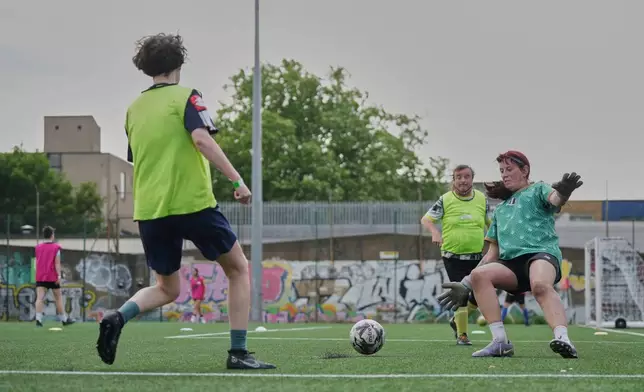 Paula Griffin, right attempt to make a save during an inclusive six a side soccer friendly tournament in London, Sunday, June 1, 2025. (AP Photo/Alastair Grant)