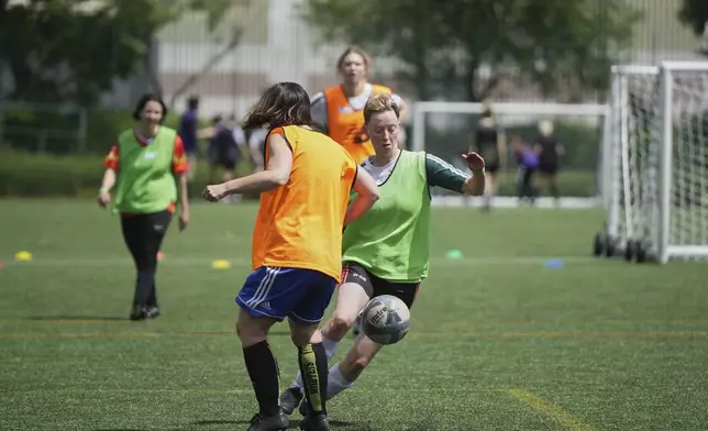 Players in actions during an inclusive six a side soccer friendly tournament in London, Sunday, June 1, 2025. (AP Photo/Alastair Grant)