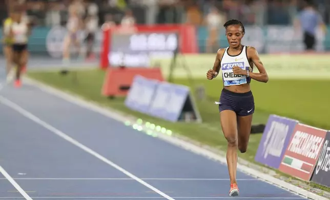 Beatrice Chebet, of Kenya, crosses the finish line to win the women 5000 meters at the Diamond League Golden Gala Pietro Mennea athletics meet at the Stadio Olimpico in Rome, Friday, June 6, 2025. (AP Photo/Gregorio Borgia)