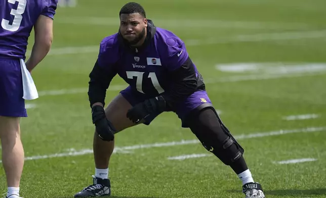 Minnesota Vikings offensive tackle Christian Darrisaw (71) takes part in drills during practice at NFL football minicamp, Tuesday, June 10, 2025, in Eagan, Minn. (AP Photo/Abbie Parr)