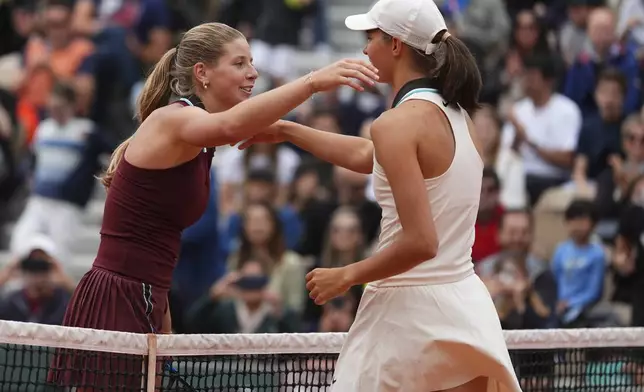 Great Britain's Hannah Klugman, left, hugs Austria's Lilli Tagger aftre losing the girl's singles final match of the French Tennis Open at the Roland-Garros in Paris, Saturday, June 7, 2025. (AP Photo/Lindsey Wasson)