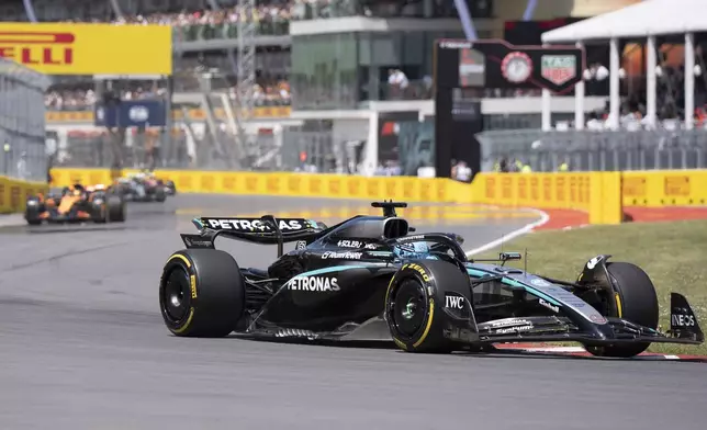 Mercedes driver George Russell, of the United Kingdom, leads the pack during the F1 Canadian Grand Prix auto race in Montreal, Sunday, June 15, 2025. (Christopher Katsarov/The Canadian Press via AP)