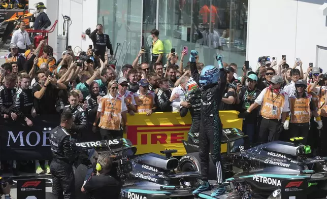 Mercedes driver George Russell, center right, of the United Kingdom, celebrates after winning the F1 Canadian Grand Prix auto race in Montreal, Sunday, June 15, 2025. (Christinne Muschi/The Canadian Press via AP)
