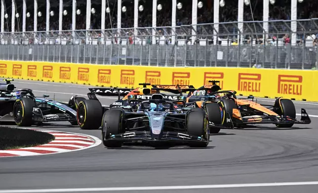 Mercedes driver George Russell, center front, of the United Kingdom, leads the pack during the F1 Canadian Grand Prix auto race in Montreal, Sunday, June 15, 2025. (Jacques Boissinot/The Canadian Press via AP)