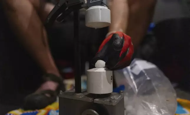 Jake Sorber prepares to crush hail in the Walmart parking lot during a Project ICECHIP operation Friday, June 6, 2025, in Levelland, Texas. (AP Photo/Carolyn Kaster)
