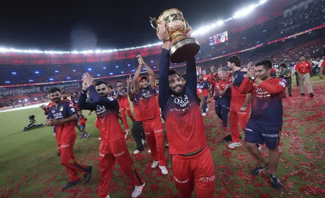 Royal Challengers Bengaluru's captain Rajat Patidar celebrates with the winners trophy after their win in the Indian Premier League final cricket match against Punjab Kings at Narendra Modi Stadium in Ahmedabad, India, Wednesday, June 4, 2025. (AP Photo/Ajit Solanki)