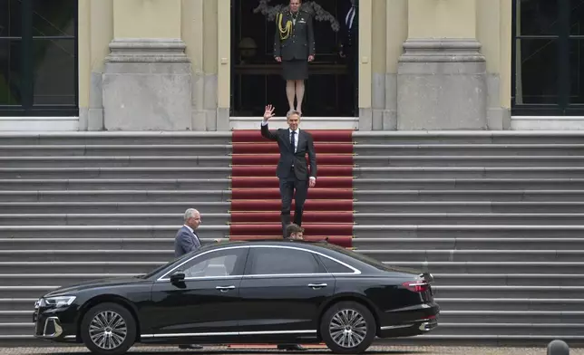 Dutch Prime Minister Dick Schoof waves after handing in the resignation of Geert Wilder's PVV party ministers to King Willem-Alexander at royal palace Huis ten Bosch in The Hague, Netherlands, Tuesday, June 3, 2025. (AP Photo/Peter Dejong)