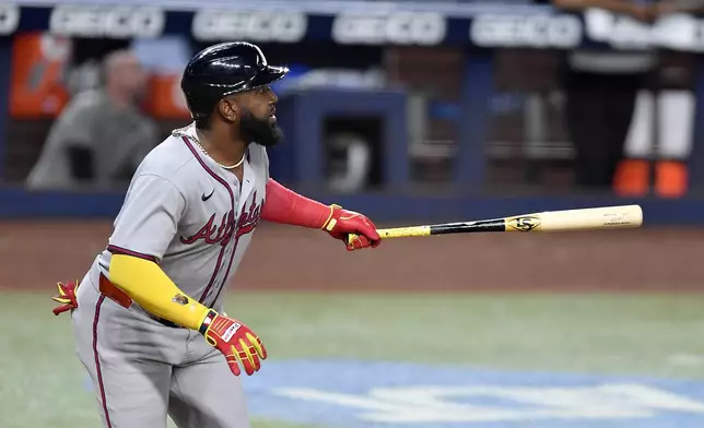 Atlanta Braves designated hitter Marcell Ozuna watches his double during the sixth inning of a baseball game against the Miami Marlins, Friday, June 20, 2025, in Miami. (AP Photo/Michael Laughlin)