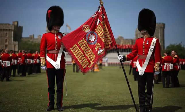 Soldiers of the 1st and 2nd Battalion (Number 7 Company) the Coldstream Guards display the King's Colour at Windsor Castle, Windsor, England, Friday, June 13, 2025. (Henry Nicholls/Pool Photo via AP)