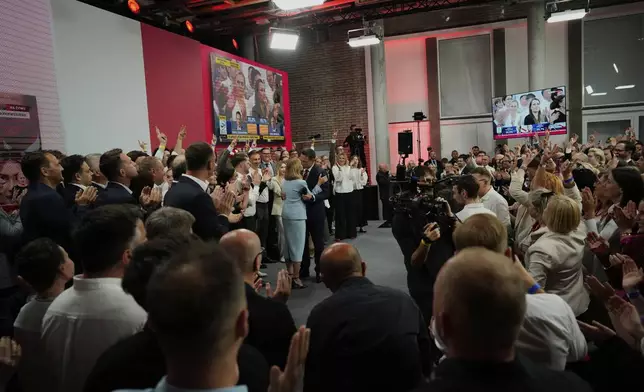 Presidential candidate Rafal Trzaskowski, a liberal pro-European Union figure, center, kisses his wife Malgorzata Trzaskowska at his headquarters after the presidential election runoff in Warsaw, Poland, Sunday, June 1, 2025. (AP Photo/Petr David Josek)