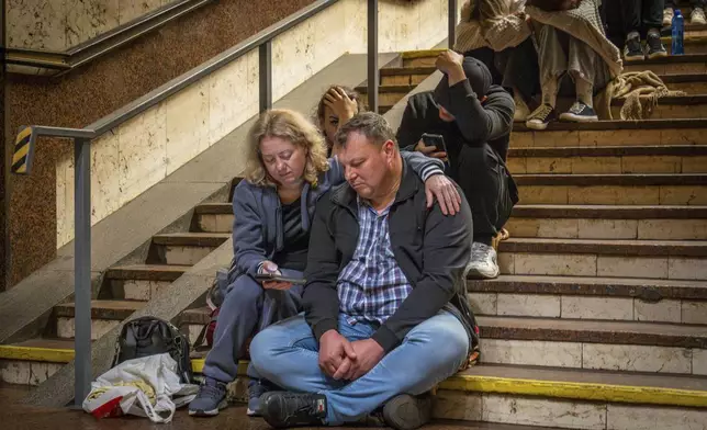 People rest in a metro station, being used as a bomb shelter, during a Russian drones attack in Kyiv, Ukraine, early Friday, June 6, 2025. (AP Photo/Dan Bashakov)