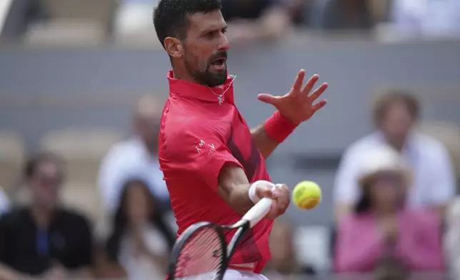 Serbia's Novak Djokovic plays a shot against Britain's Cameron Norrie during their fourth round match of the French Tennis Open at the Roland-Garros stadium in Paris, Monday, June 2, 2025. (AP Photo/Thibault Camus)