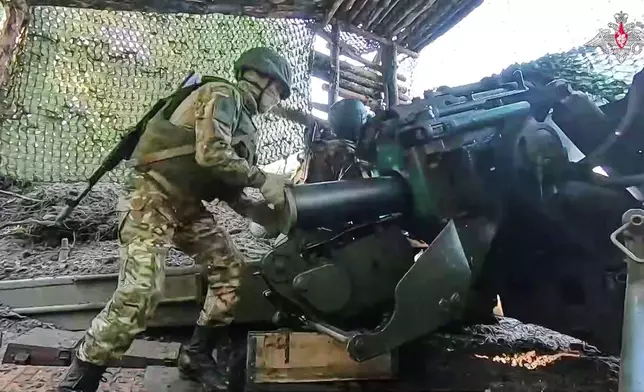 In this photo taken from video distributed by Russian Defense Ministry Press Service on Tuesday, June 24, 2025, a Russian soldier prepares Giatsint-B 152 mm field gun to fire towards Ukrainian position on an undisclosed location in Ukraine. (Russian Defense Ministry Press Service via AP)