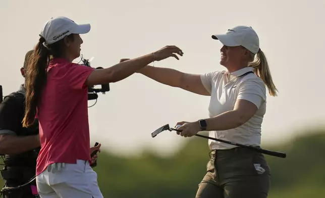 Maja Stark, of Sweden, hugs Julia Lopez Ramirez, of Spain, after winning the U.S. Women's Open golf tournament at Erin Hills Sunday, June 1, 2025, in Erin, Wis. (AP Photo/Jeff Roberson)