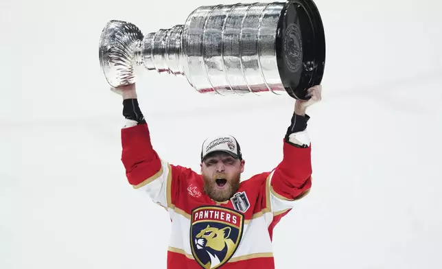 Florida Panthers' Sam Bennett (9) raises the Stanley Cup after defeating the Edmonton Oilers in Game 6 of the NHL hockey Stanley Cup Final in Sunrise, Fla., Tuesday, June 17, 2025. (Nathan Denette/The Canadian Press via AP)