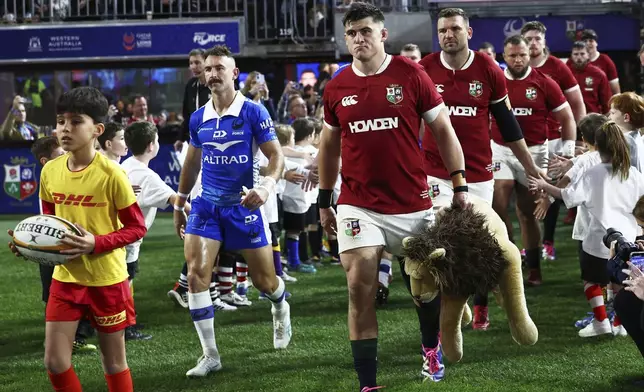 Dan Sheehan of the British &amp; Irish Lions leads his team onto the field for their rugby match against the Western Force in Perth, Australia, Saturday, June 28, 2025. (AP Photo/Trevor Collens)