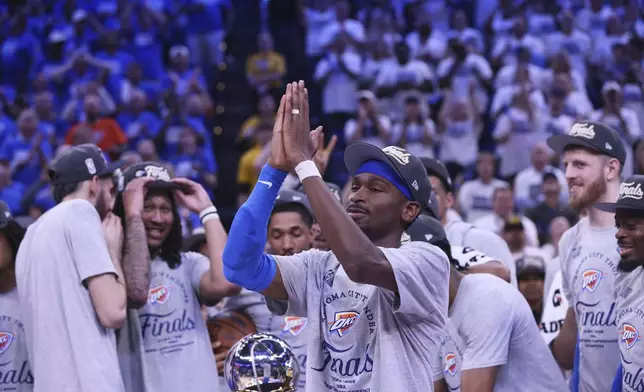 Oklahoma City Thunder guard Shai Gilgeous-Alexander (2), front, celebrates with teammates after Game 5 of the Western Conference finals of the NBA basketball playoffs against the Minnesota Timberwolves, Wednesday, May 28, 2025, in Oklahoma City. (AP Photo/Nate Billings)