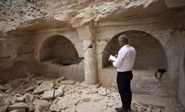 Hassan Ismail of the Idlib Museum takes notes at a Byzantine underground tomb complex, believed to be over 1,500 years old, uncovered by a contractor during reconstruction of a war-damaged house in Maarat al-Numan, Idlib suburb, Syria, on Friday, May 30, 2025. (AP Photo/Omar Albam)