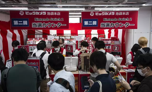 Customers lin up to purchase Nintendo Switch 2 at an electronics retailer in Tokyo, Thursday, June 5, 2025. (AP Photo/Louise Delmotte)