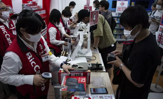 A customer purchases Nintendo Switch 2 at an electronics retailer in Tokyo, Thursday, June 5, 2025. (AP Photo/Louise Delmotte)