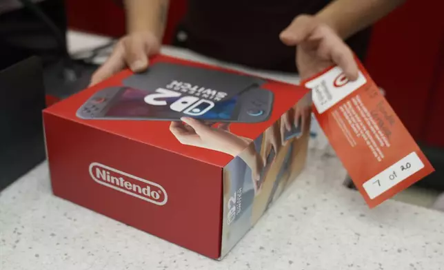 A customer receives the new Nintendo Switch 2 video game console at a Target store on Thursday, June 5, 2025 in Chicago. (AP Photo/Kiichiro Sato)