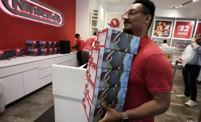 A stack of Nintendo Switch 2 devices is restocked at the Nintendo store in New York's Rockefeller Center, Thursday, June 5, 2025. (AP Photo/Richard Drew)
