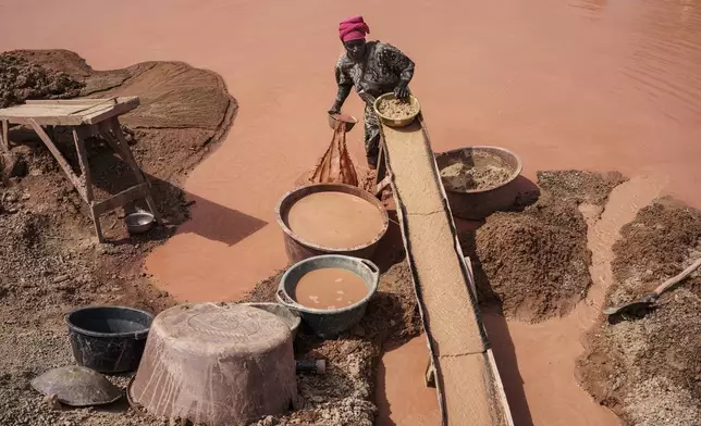A woman processes gold at a mining site in the Kedougou region of Senegal, Jan. 16, 2025. (AP Photo/Annika Hammerschlag)