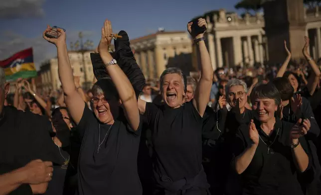 Faithful react after the announcement of the newly elected Pope Leo XIV at the Vatican, May 8, 2025. (AP Photo/Francisco Seco)
