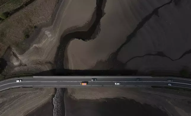 Traffic crosses a bridge over the Woodhead Reservoir in Derbyshire as England experiences a significant drought, May 19, 2025. (AP Photo/Jon Super)