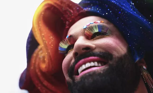 A reveler smiles during the annual Pride parade marking LGBTQ+ Pride Month, in Sao Paulo, Sunday, June 22, 2025. (AP Photo/Ettore Chiereguini)