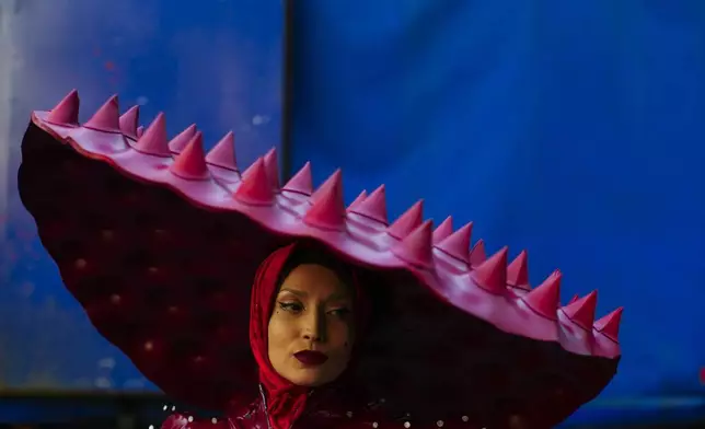 A woman dressed in a Lady Gaga iconic outfit takes part in the annual Gay Pride parade marking LGBTQ+ Pride Month, in Santiago, Chile, Saturday, June 21, 2025. (AP Photo/Esteban Felix)