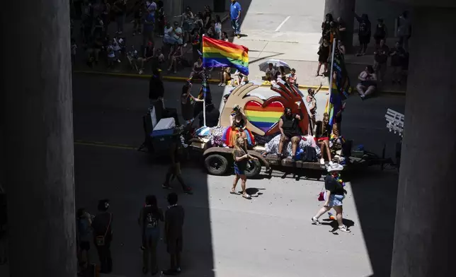 A float passes under an overpass during the Kentuckiana Pride Parade on Saturday, June 21, 2025, in Louisville, Ky. (AP Photo/Jon Cherry)