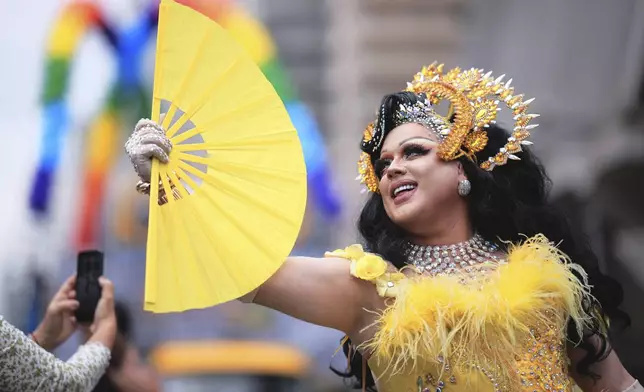 A reveler strikes a pose during the annual Pride parade marking LGBTQ+ Pride Month, in Sao Paulo, Sunday, June 22, 2025. (AP Photo/Ettore Chiereguini)